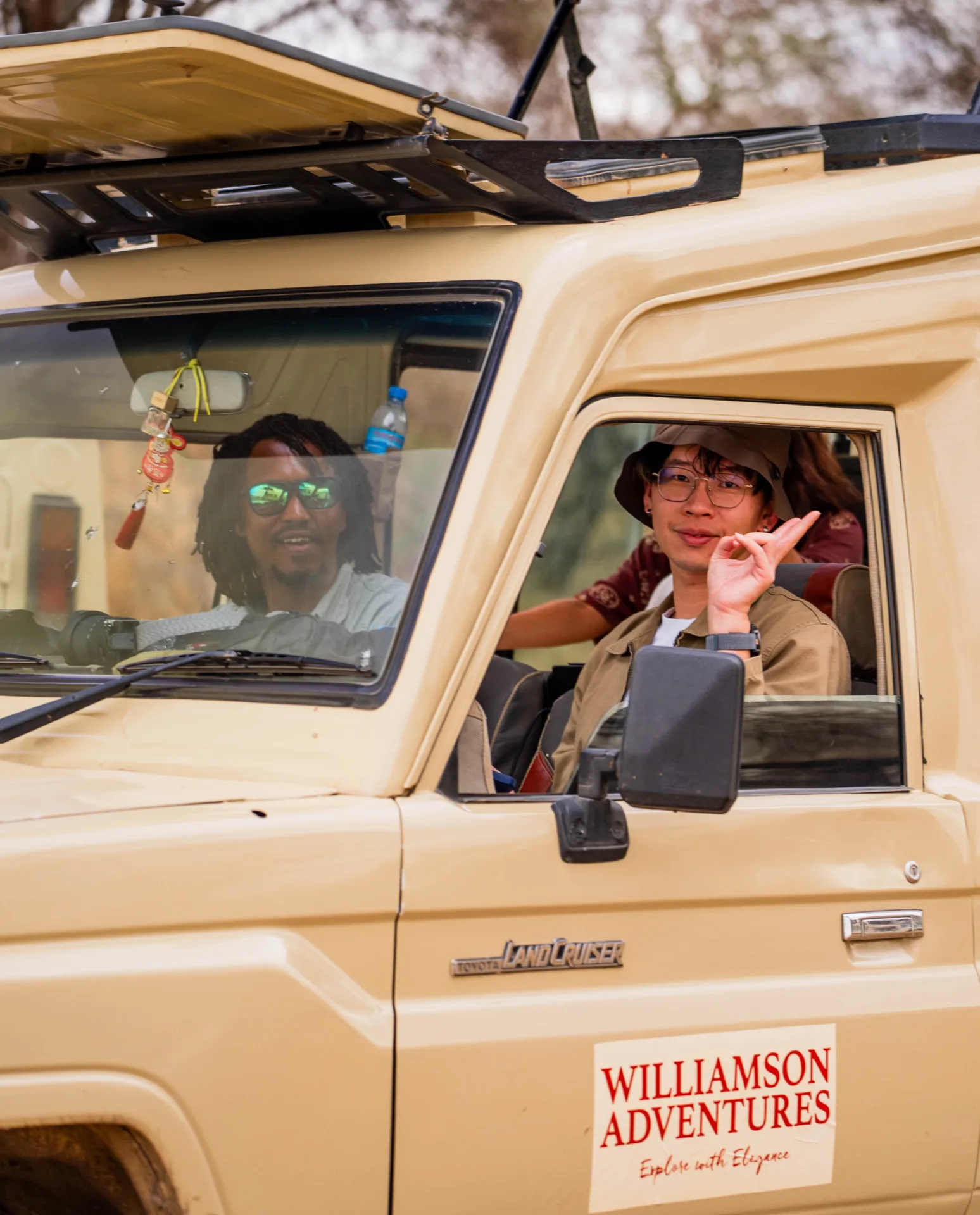 Williamson Adventures guide with a guest in the safari vehicle